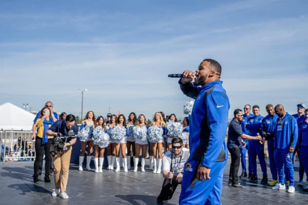 LA Rams NFL football player speaks to fans at experiential marketing event before game