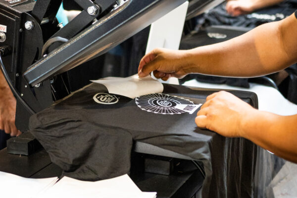 Person finalizing heat transfer for t-shirt