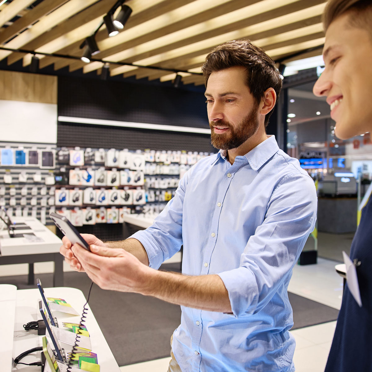 Customer interacting with a product during an in-store activation, showcasing retail experiential marketing and immersive shopping experiences that drive engagement and sales.