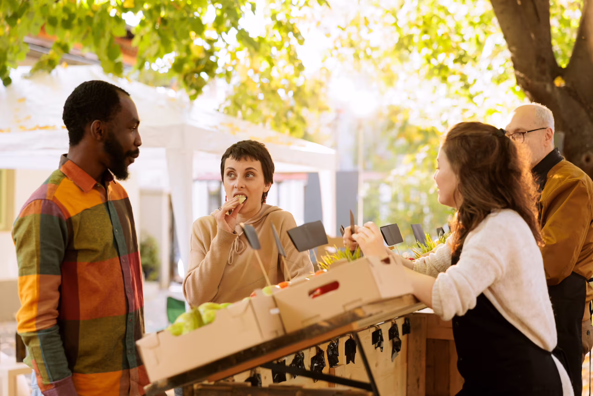 Outdoor product sampling at a farmers market - consumers tasting CPG food during an experiential marketing activation.