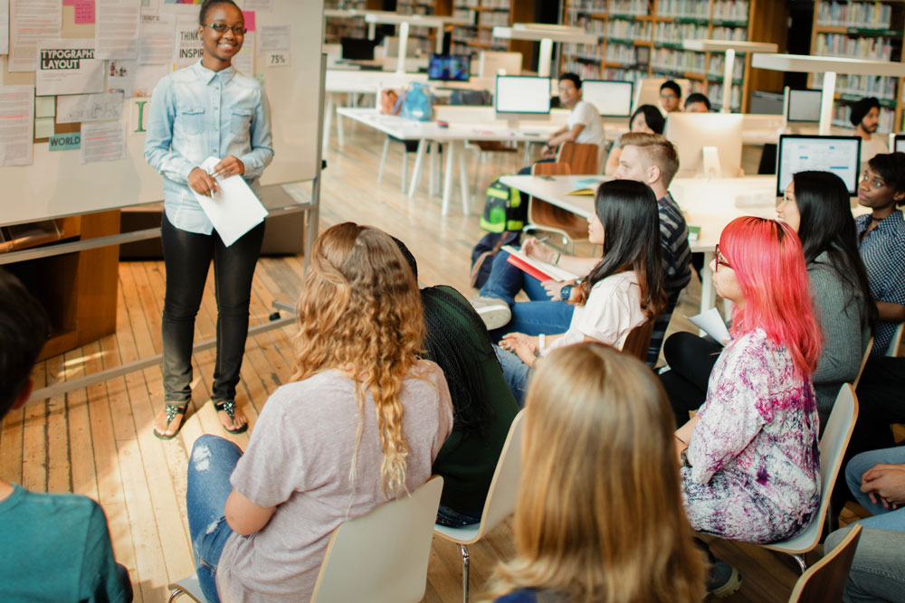 Financial literacy workshop presenter leading a community financial education event for young adults